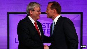 Australian Prime Minister Kevin Rudd talks with conservative opposition leader Tony Abbott before the debate on 11 August 2013