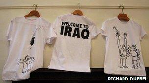 T shirts showing satirical cartoons by Abdul Raheem Yassir