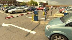 Car driving up to parking barrier