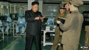 Kim Jong-un looks at smartphone