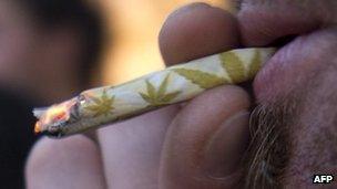 A young man smokes a marijuana joint during a demonstration demanding a new law on cannabis in Montevideo 8 May 2013