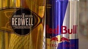 Pint of Redwell beer and can of Red Bull energy drink