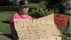 A demonstrator outside provincial court in Halifax, Nova Scotia, on 15 August 2013