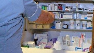 Nurse dispensing medicine from a trolley