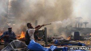 A supporter of the Muslim Brotherhood and Egypt's ousted president Mohamed Morsi fires fireworks towards police during clashes in Cairo on August 14, 2013