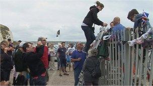 Campaigners climb over barriers