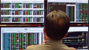 An trader looking at market boards