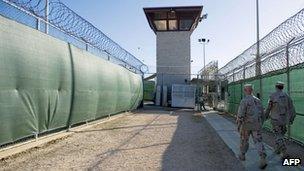 file photo reviewed by the US military, show two members of the military walking out of the "Camp Six" detention facility of the Joint Detention Group at the US Naval Station in Guantanamo Bay, Cuba 12 January 2012