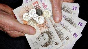 Hands holding cash and coins