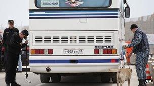 Russian police with a sniffer dog check a bus entering the Olympic Park in Sochi. Photo: April 2013