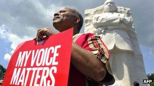 A man displays a placard at Martin Luther King Jr, memorial on 24 August 2013 in Washington, DC