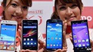 Models display various smartphones