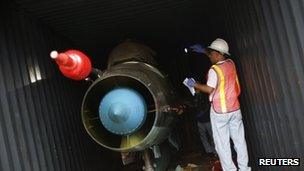 A man works in a container with the MiG-21 jets found inside the North Korean Chong Chon Gang vessel where an alleged Soviet-built radar control system for surface-to-air missiles was found, at the Manzanillo Port in Colon, Panama on 21 July, 2013.