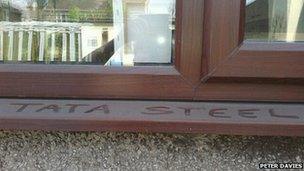 Words Tata Steel written in dust on external window sill at Port Talbot home of Peter Davies