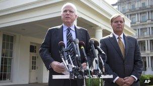 Senator John McCain accompanied by Senator Lindsey Graham speaks with reporters outside the White House in Washington 2 September 2013