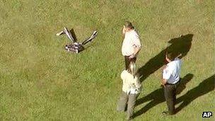 Image from ABC video of investigators standing near a remote controlled toy helicopter that apparently struck and killed a 19-year-old man 5 September 2013
