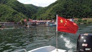 A North Korean military camp is visible from a boat on the Yalu River