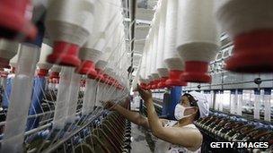 A labourer is seen working in a textile factory in Huaibei, in north China's Anhui province