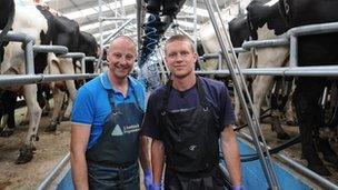 Chris Jackson with Richard Dayment in the milking parlour