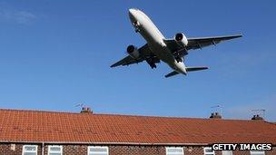 Jet plane over houses