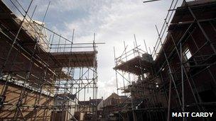 Newly-built homes with scaffolding on them