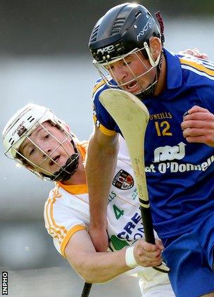 Antrim's Tiernan Coyle battles with Clare's Cathal Malone at Thurles