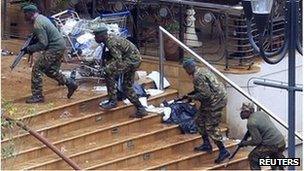 Kenya Defence Forces soldiers take their position at the Westgate shopping centre, on the fourth day since militants stormed into the mall, in Nairobi September 24, 2013.