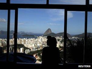 Woman looks out window over Rio