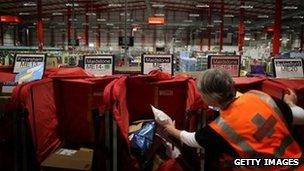 A postal worker in a sorting office