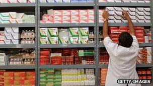 Man reaching for a package in a pharmacy