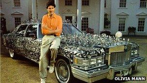 Uri Geller with a car covered in spoons