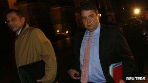 Leader of of Germany's Social Democratic Party (SPD) Sigmar Gabriel (R) leaves after preliminary coalition talks with Germany"s conservative (CDU/CSU) parties at the Parliamentary Society in Berlin October 15,