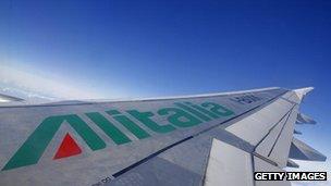 A picture of an Alitalia airplane wing