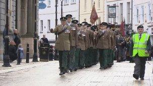 The regimental banner is paraded through Enniskillen