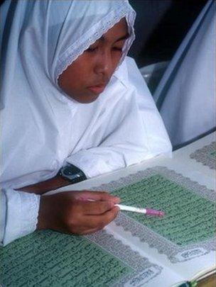 A Muslim girl studies the Koran at a Brunei school