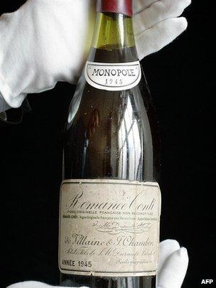 A rare bottle of French 1945 vintage Romanee-Conti wine is displayed at auction