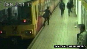 A passenger falls to the floor after trying to open a train door in Newcastle