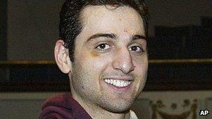 Tamerlan Tsarnaev smiles after accepting the trophy for winning the 2010 New England Golden Gloves Championship in Lowell, Massachusetts 17 February 2010