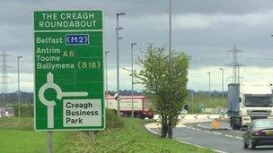 Traffic near road sign showing A6 route