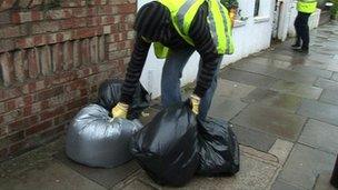 Dustbin man collecting bin bags