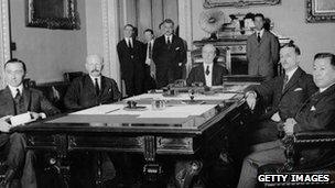 Diplomats pose for a photograph around the negotiating table following the ratification of the Four Power Pacific Treaty