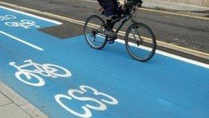 Person riding a bicycle on a Barclays Cycle Superhighway