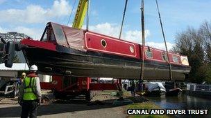 Narrowboat being lifted out of river in Aylesbury, Bucks
