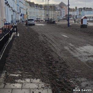 This shows shingle left on Aberystwyth seafront after the waves had crashed over it