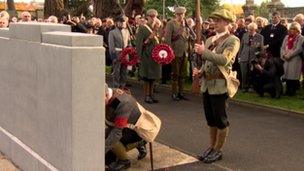 People in UVF costumes laid wreathes at the war graves commission memorial