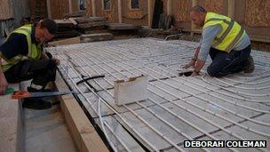 Workers lay new under-floor heating in Bath Abbey