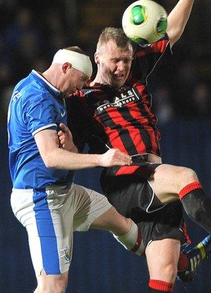 Linfield's Kyle McVey and Crusaders striker Jordan Owens battle for the high ball