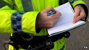 Police officer writing in a notebook
