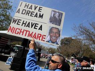 A Tea Party protestor holds a sign during a rally in Pleasanton, California on 15 April 2010