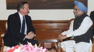 India's Prime Minister Manmohan Singh speaks with British Prime Minister David Cameron in Delhi